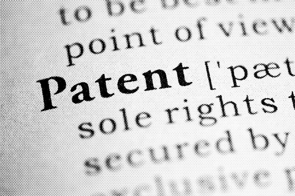Abstract photo of dictionary showing the definition of the word 'patent'.