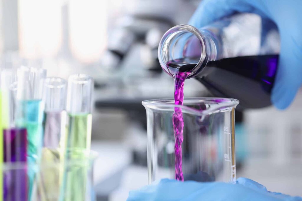 scientist pouring pink chemicals - Industries - IP Guardian Pty Ltd